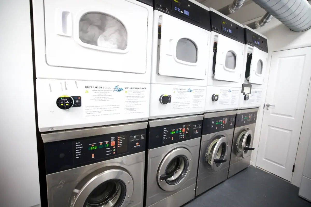 Rows of washers and dryers inside EasySpin Laundrette